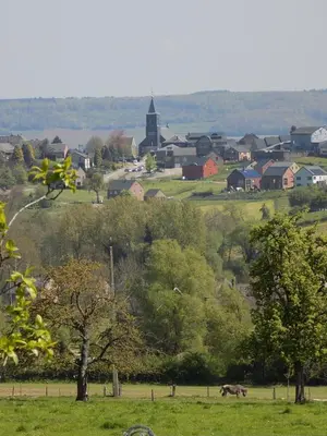 a town with a field of trees and a town with a church at (La parenthese) in Hombourg