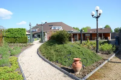 a vase sitting in the middle of a garden at Hotel Monte Cristo in Hoeselt