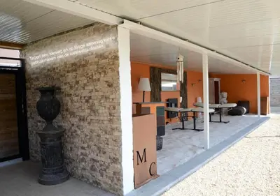 a room with a brick wall with a vase on it at Hotel Monte Cristo in Hoeselt