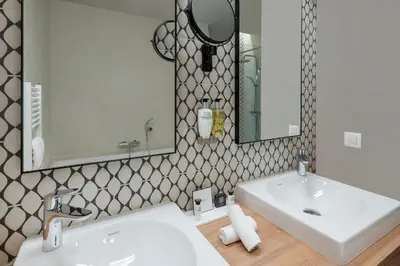a bathroom with a white sink and a mirror at Martin's Rentmeesterij in Bilzen
