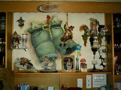a shelf with a painting of a teapot on a wall at gasthof lederhose in Diepenbeek