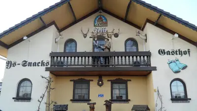 a building with a balcony on the side of it at gasthof lederhose in Diepenbeek