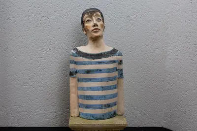 a statue of a man in a striped shirt on a wall at Bed 'n Blues **** in Halen