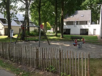 a playground with a swing set and a stop sign at Ceder 9 Hengelhoef in Houthalen-Helchteren