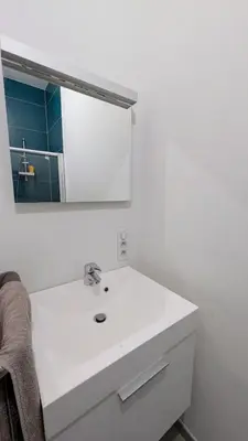 a bathroom with a white sink and a mirror at Augustins in Liège