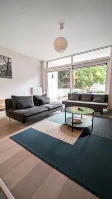 a living room with a couch and a table at Augustins in Liège