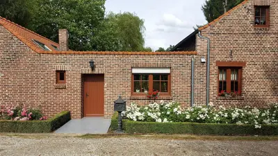 a brick house with flowers in front of it at De Stille Weier in Genk