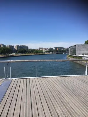 a wooden dock with a view of a river at Au 194 in Liège