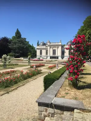 a white house with red flowers in front of it at Au 194 in Liège