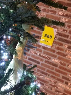 a christmas tree with a big sign on it at B&B Sasput in Hasselt
