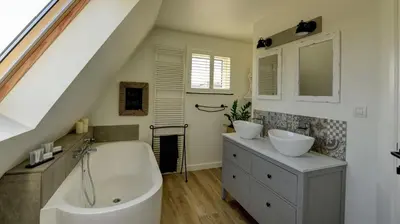 a bathroom with two sinks and a bath tub at B&B Eikenlaan 12 in Genk