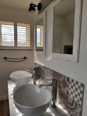 a bathroom with two sinks and a mirror at B&B Eikenlaan 12 in Genk