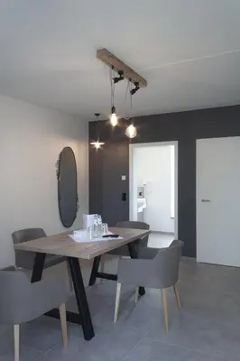 a dining room with a wooden table and chairs at Hotel Restaurant Tychon AG in Eynatten