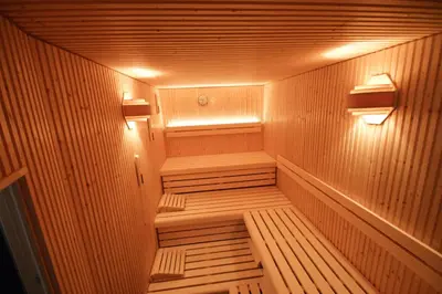 a wooden sauna with two lights on the inside at Hotel Restaurant Tychon AG in Eynatten