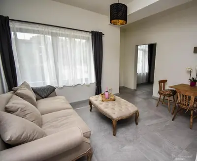 a living room with a couch and a coffee table at B&B De Bloesem in Hoeselt