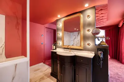 a bathroom with a sink and a mirror at Van der Valk Hotel Liège Congres in Liège