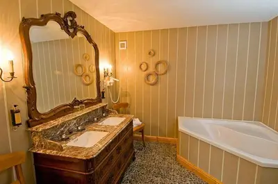 a bathroom with two sinks and a tub and a mirror at Het Pachthof in Borlo