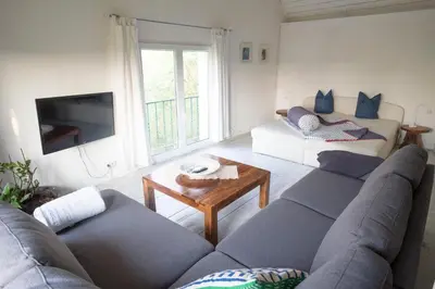 a living room with a couch and a table at Bellevue Maison de Greunebennet in Plombières