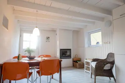 a dining room with a table and orange chairs at Bellevue Maison de Greunebennet in Plombières