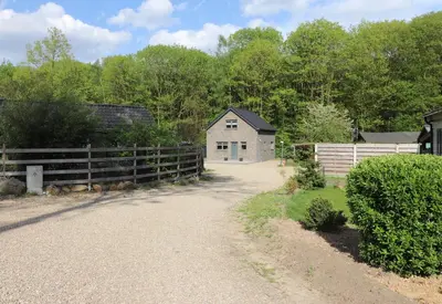 a driveway leading to a barn and a fence at Stefjes Holiday Home in Dilsen-Stokkem