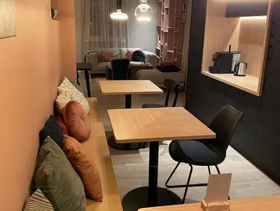 a room with two tables and a couch at B&B Maris Logies in Hasselt