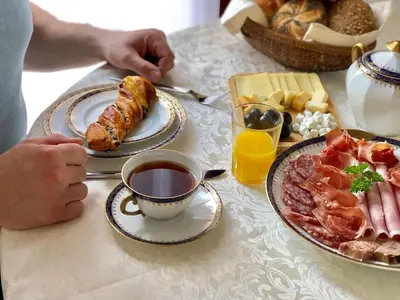 a table with plates of food and a cup of tea at B&B Secret Garden Adults only in Voeren