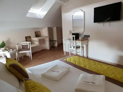 a living room with a large bed and a table at B&B Secret Garden Adults only in Voeren