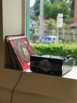 a radio sitting on a window sill next to a clock at Staying with the artist in Teuven