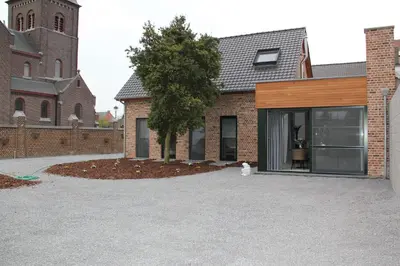 a cat is sitting in front of a church at B&B de Taller-Hoeve in Maasmechelen
