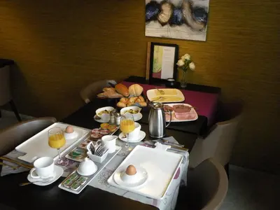 a table with a breakfast of eggs and bread at B&B de Taller-Hoeve in Maasmechelen