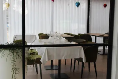 a dining room with white tables and chairs and balloons at MAIO B&B en Dinner in Zonhoven
