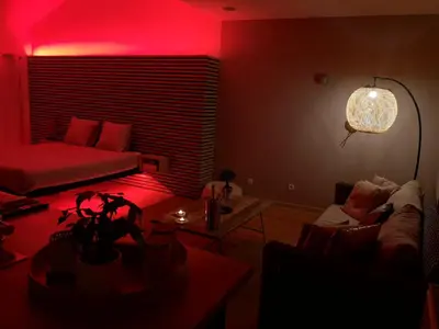a living room with a couch and a red light at La bulle D'orée in Chaudfontaine