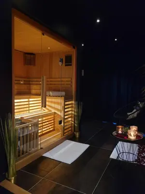 a room with a sauna with a table in it at La bulle D'orée in Chaudfontaine