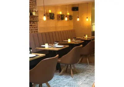 a restaurant with wooden tables and chairs and lights at Boutique Hotel Caelus VII in Tongeren