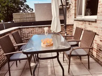 a table with a bowl of fruit on a patio at Casa Roman - nieuwe vakantiewoning - Deluxe 4p - Relax 4p - Comfort 4p -- ---Cosy 2p in Zonhoven