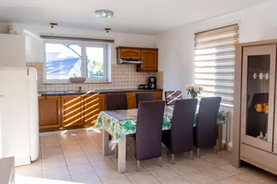 a kitchen with a table and chairs in a kitchen at Casa Roman - nieuwe vakantiewoning - Deluxe 4p - Relax 4p - Comfort 4p -- ---Cosy 2p in Zonhoven