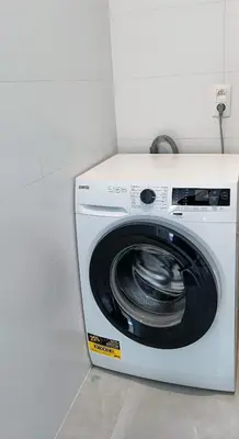 a white washing machine sitting in a room at Casa Roman - nieuwe vakantiewoning - Deluxe 4p - Relax 4p - Comfort 4p -- ---Cosy 2p in Zonhoven