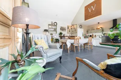 a living room with chairs and a table at B&B Woods and Wine in As