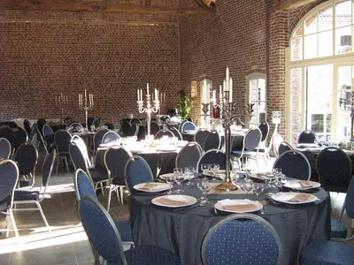 a room filled with tables and chairs with at Hotel Oude Eycke in Maaseik