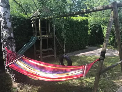 a hammock hanging from a tree in a garden at Holiday Home 'Beautifull Water' in Lanaken