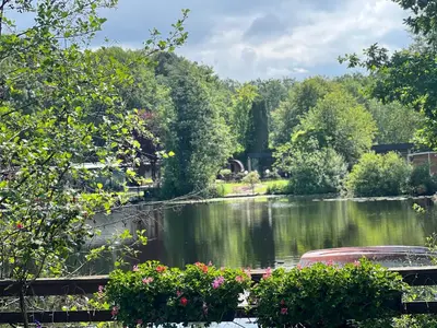 a lake with a boat in the middle of it at Holiday Home 'Beautifull Water' in Lanaken