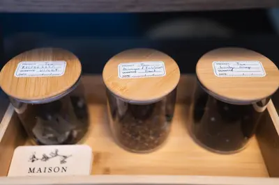 three jars of masillon on a shelf with labels at Appartement atypique - coeur historique de Liège in Liège