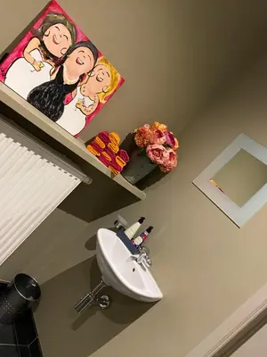 a bathroom with a white toilet and a sink at Cosy Studio met Zwembad in Beringen