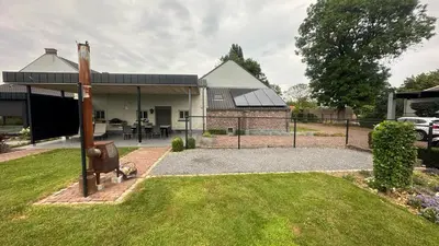 a house with a fence and a grass yard at Bed & Bets! in Geetbets