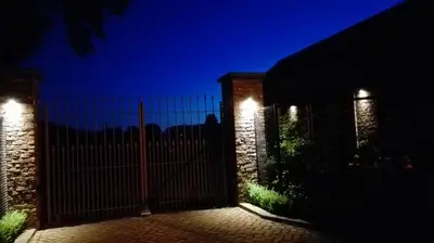 a fence with lights on it at night at Bed & Bets! in Geetbets