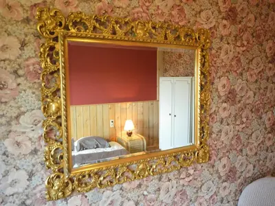 a gold mirror on a wall with a bedroom at Trooz Villa with Pool & Sauna in Trooz
