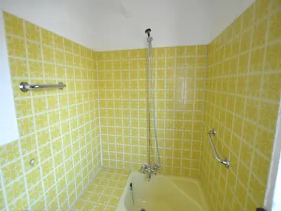 a yellow tiled bathroom with a shower and a tub at Trooz Villa with Pool & Sauna in Trooz