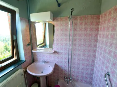 a pink tiled bathroom with a sink and a shower at Trooz Villa with Pool & Sauna in Trooz