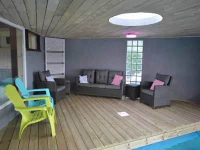 a living room with a couch and chairs and a pool at Trooz Villa with Pool & Sauna in Trooz