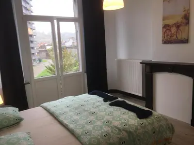 a bedroom with a bed and a window at Leonard room in Liège